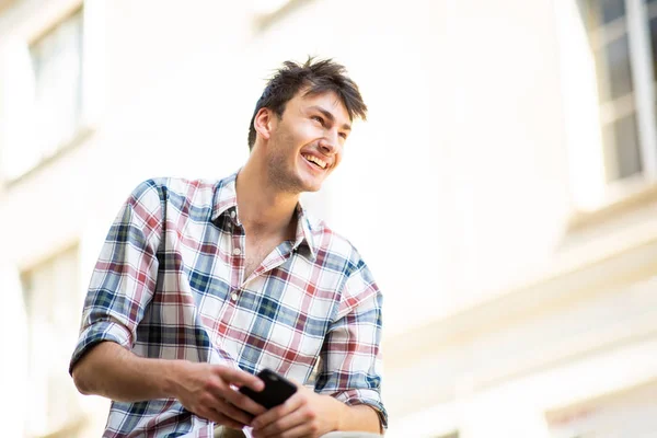 Portrait Handsome Young Guy Sitting Holding Mobile Phone Hand — Stock Photo, Image