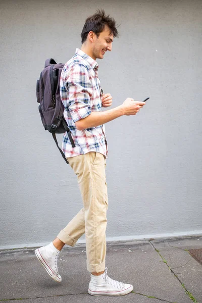 Full Length Side Portrait Happy Young Man Walking Cellphone Bag — Stockfoto