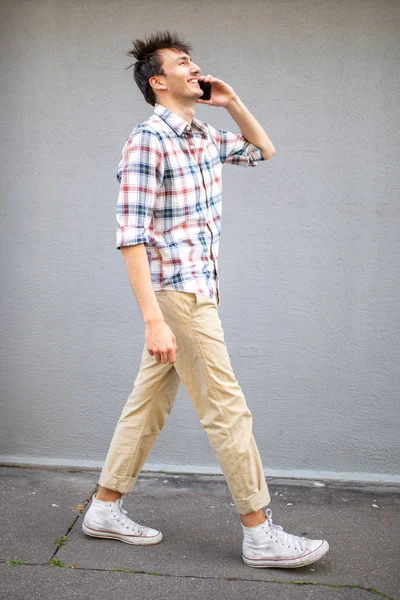 Full Length Side Portrait Happy Young Man Walking Talking Cellphone — Stock Photo, Image