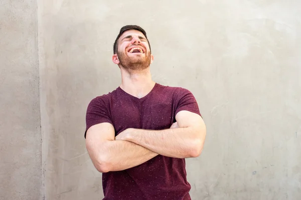Portrait Young Man Arms Crossed Laughing Gray Wall — Stock Photo, Image
