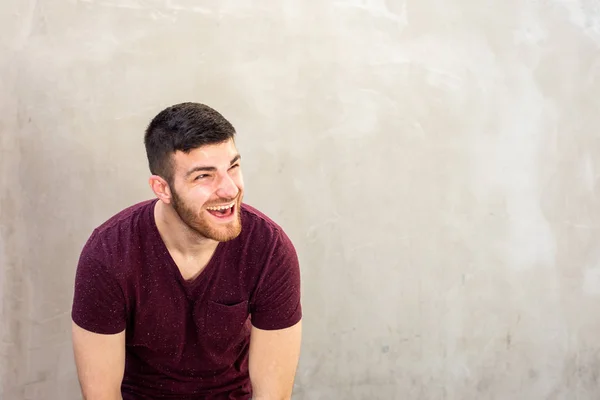 Portret Młodego Mężczyzny Brodą Śmiejącego Się Przy Ścianie — Zdjęcie stockowe