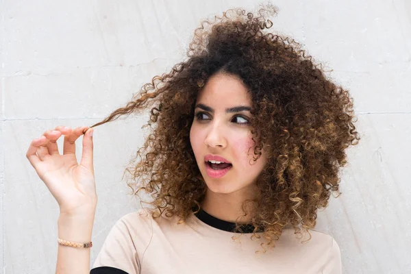 Close Portrait Young Woman Pulling Curly Hair Looking Puzzled Expression — Stock Photo, Image