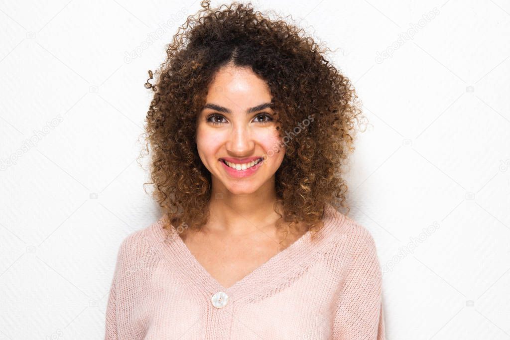 Close up horizontal portrait of happy young African american woman with curly hair by white background