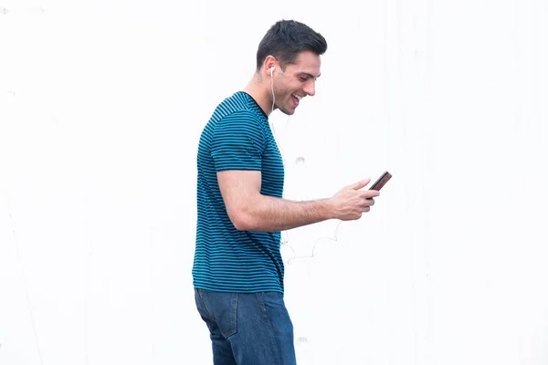 Portrét Šťastný Mladý Muž Poslech Hudby Mobilním Telefonem Sluchátka Bílém — Stock fotografie