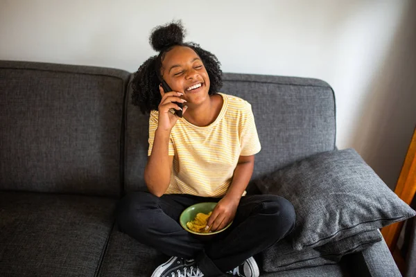 Porträtt Afrikansk Flicka Sitter Soffan Prata Med Mobiltelefon Och Äta — Stockfoto