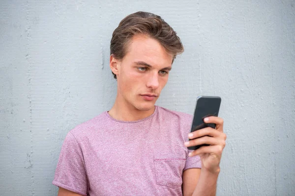 Close Portrait Serious Young Man Leaning Wall Looking Cellphone — Stock Photo, Image
