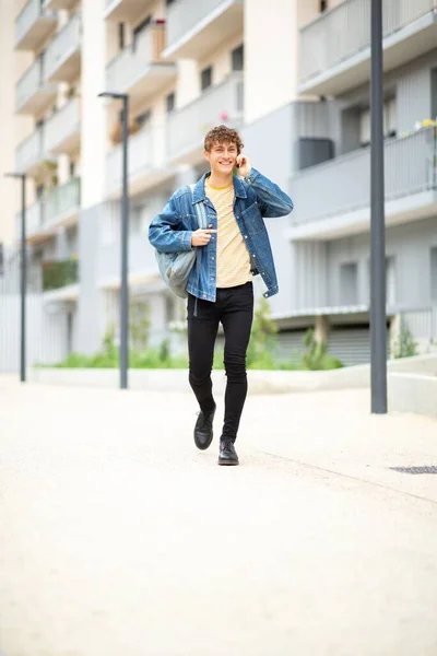 Full Length Portrait Happy Young Man Walking Talking Mobile Phone — Stock Photo, Image