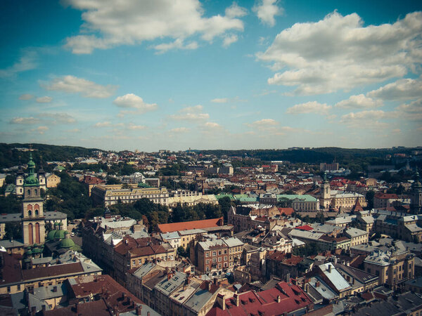 Top view of the Ukrainian city of Lviv city with a wonderful picturesque image of foliage of trees of ancient Gothic buildings, buildings of the Cathedral Museum. with many colorful houses