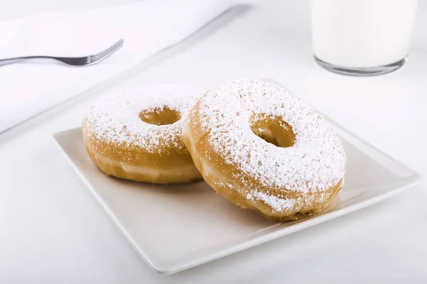 Donuts Covered Icing Sugar Plate White Background Accompanied Glass Milk — Stock Photo, Image