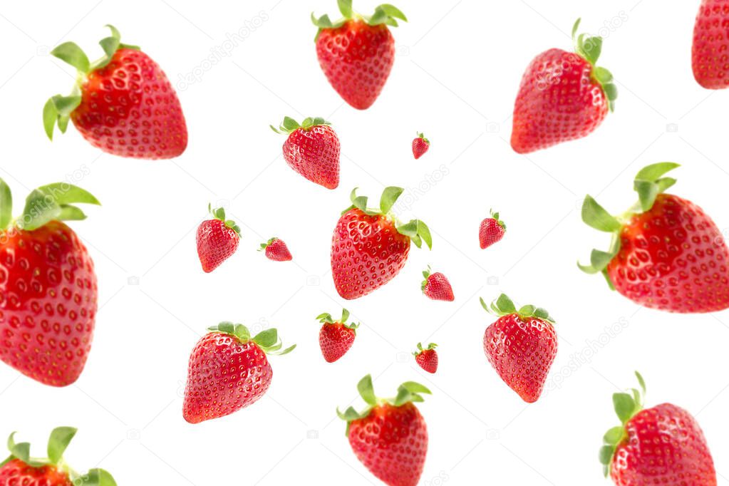 Isolated falling fruits. Photograph of fresh strawberries flying isolated on white background. Selective focus. Food levitation concept. Creative food layout. High resolution image.