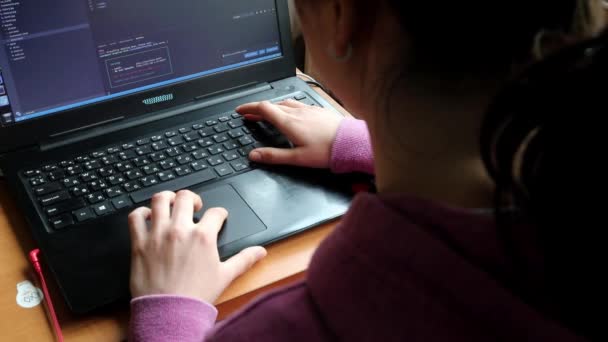 Girl at computer while studying online programming at home near the window — Stock Video