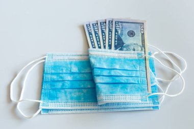 Tıbbi maskeler ve 50 dolarlık banknotlar, solunum yolunun virüslerden korunması için daha yüksek fiyatların sembolü..