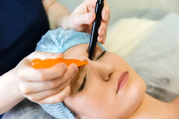 Acupressure of the face with jade sticks for a young girl. Effects on the points of the face with massage sticks.