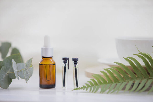 Essential oil bottles arrangement isolated on white