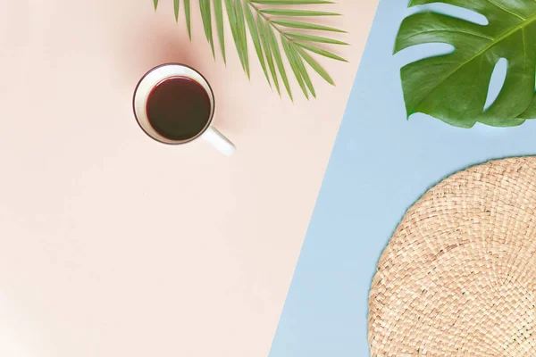 Ronde rieten standaard en tropische palmbladeren met kopje koffie op roze achtergrond. Fltlay stijl concept met tekst plaats — Stockfoto