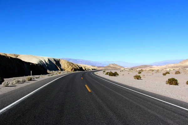 Weg in de Death Valley National Park met blauwe hemelachtergrond, Californië — Stockfoto