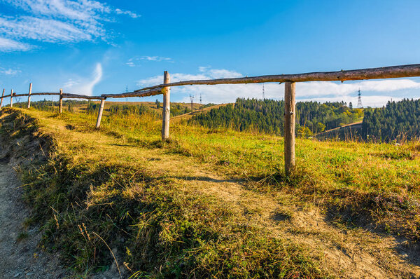 wooden fence along the path through countryside