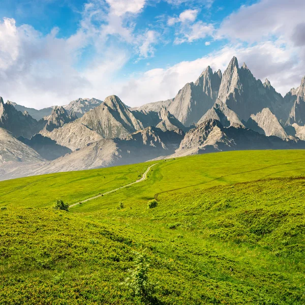 Grassy slopes and rocky peaks composite — Stock Photo, Image