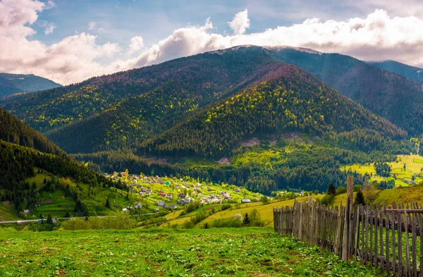 Village in valley on a cloudy springtime day — Stock Photo, Image