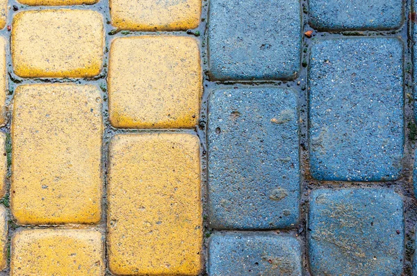 Yellow and blue cobbles of pavement texture — Stock Photo, Image