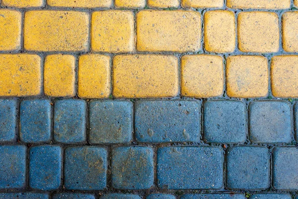 Yellow and blue cobbles of pavement texture — Stock Photo, Image
