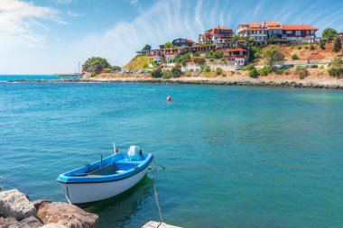 Eski bir kasabanın limanında tekneler. Popüler seyahat merkezi. Harika güneşli bir hava. Uzakta eski balıkçı evleri ve eski mimari