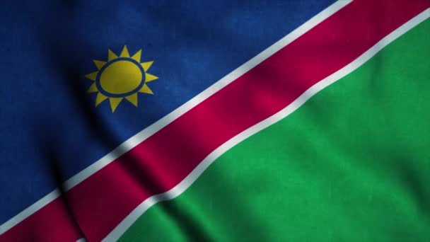 Namibia flag waving in the wind. National flag of Namibia. Sign of Namibia seamless loop animation. 4K — Stock Video