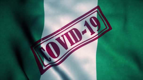 Timbro Covid-19 sulla bandiera nazionale della Nigeria. Concetto di coronavirus — Video Stock