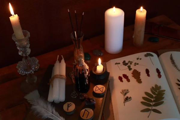 magic ritual of the alchemist with candles, runes and symbols