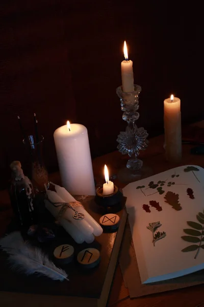 magic ritual of the alchemist with candles, runes and symbols