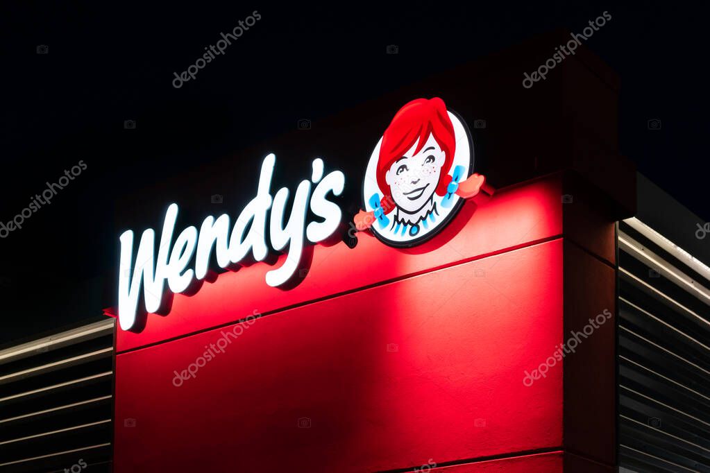 HUDSON, WI/USA - MARCH 8, 2020: Wendy's restaurant at twighlight and trademark logo.