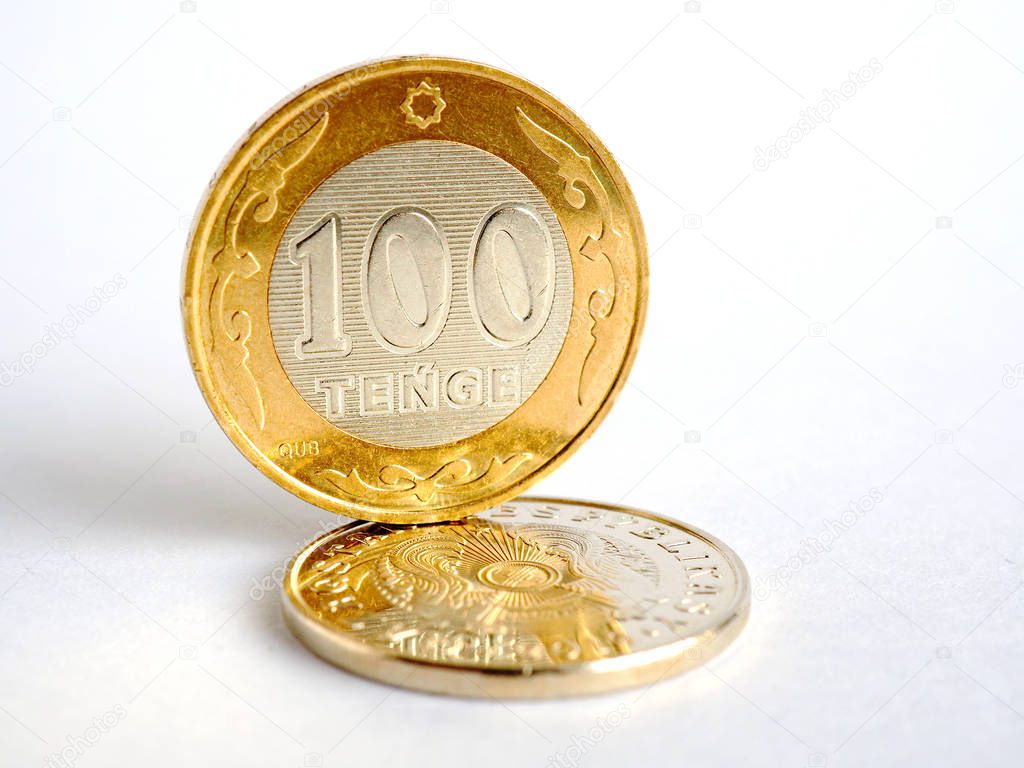 Kazakh coins of a new sample, issued in 2019, inscriptions in Latin letters. Denomination in 100 and 50 tenge. White background, not isolated. The economy and central bank of Kazakhstan. Close-up