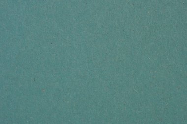 Yeşil bir karton yaprağın yüzeyi. Sakinleştirici arka plan ya da duvar kağıdı. Selüloz lifli pürüzlü doğal kağıt dokusu. Yukarıdan bak. Yakın plan.