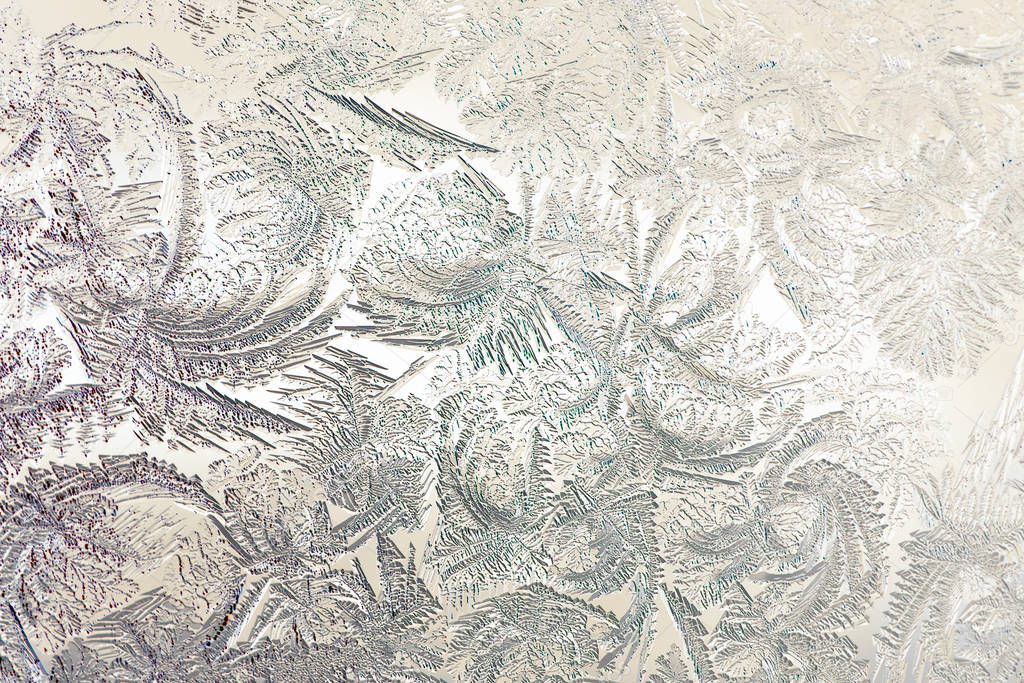 Pattern of magical fantastic plants. Abstract light yellow beige background or wallpaper. Drawing of ice on a window pane in winter. Low contrast