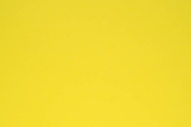 Sarı renkli kağıt. Yüzeye çıkın. Yukarıdan bak. Parlak doymuş arkaplan veya duvar kağıdı