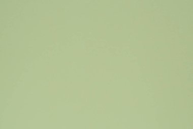 Açık yeşil renkli kağıt. Yüzey düzensizlikleri, lekeler ve gözenekler. Yukarıdan bak. Arkaplan ya da duvar kağıdı