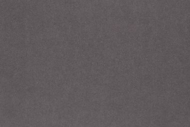 Gri renkli kağıt. Yüzey dokusu, lifler ve düzensizlikler görülebilir. Yukarıdan bak. Koyu arkaplan veya duvar kağıdı