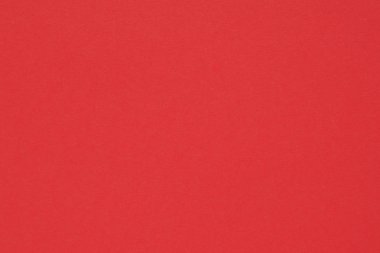 Kırmızı renkli kağıt. Parlak doymuş arka plan ya da duvar kağıdı. Yüzey düzensizlikleri, lekeler ve gözenekler. Yukarıdan görüntüle
