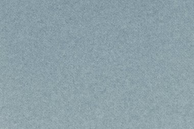 Mavi renkli kağıt. Hafif arkaplan ya da duvar kağıdı. Yüzeye yakın çekim dokusu, lifler ve düzensizlikler görülebilir. Yukarıdan bak. Makro