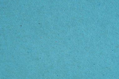 Açık mavi karton yüzeyi. Selüloz lifli pürüzlü doğal kağıt dokusu. Arkaplan ya da duvar kağıdı. Yukarıdan yukarıdan bir görüntü. Makro
