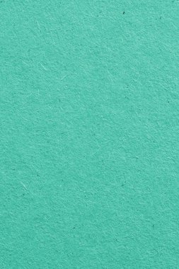 Turkuaz karton yüzeyi. Selüloz lifli pürüzlü kağıt dokusu. Doymuş akuamarin. Dikey arkaplan ya da duvar kağıdı. Yukarıdan yukarıdan bir görüntü. Makro