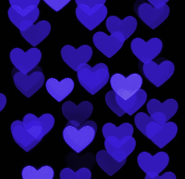 Heart bokeh background, photo blurry objects, blue on black — Stock Photo, Image