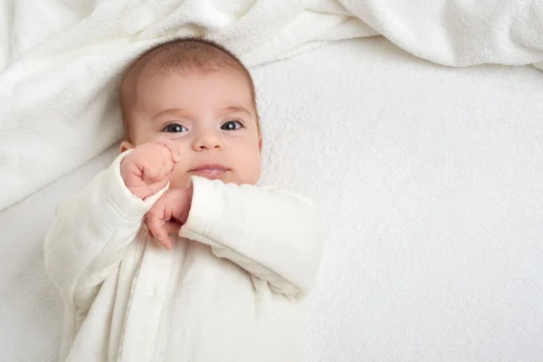 Babyporträt liegt auf weißem Handtuch im Bett — Stockfoto