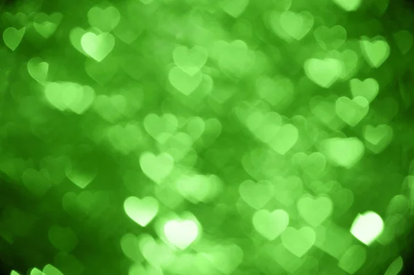 Zielone serce bokeh zdjęcie w tle, tło wakacje z abstrakcyjna — Zdjęcie stockowe