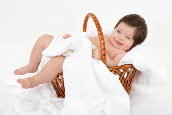 Baby in basket on white towel, health care concept — Stock Photo, Image