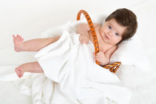 Baby in basket on white towel, healthcare concept — Stock Photo, Image