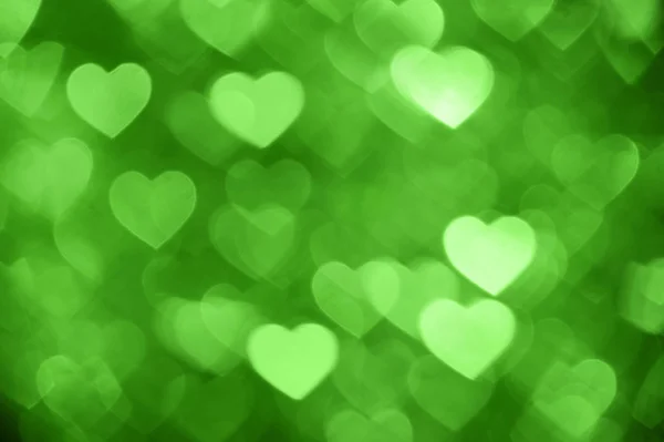 Zielone serce bokeh zdjęcie w tle, tło wakacje z abstrakcyjna — Zdjęcie stockowe