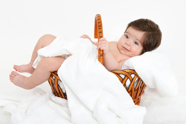 Baby in basket on white towel, healthcare concept — Stock Photo, Image