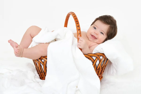 Baby in basket on white towel, healthcare concept — Stock Photo, Image