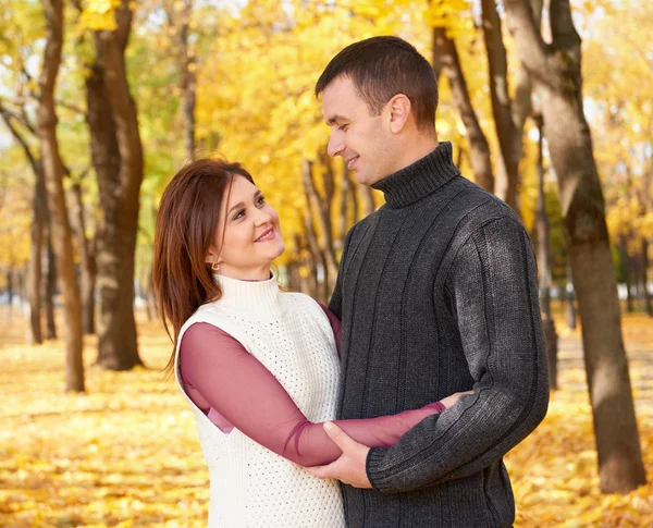 Personas románticas, feliz pareja adulta abrazar en el parque de la ciudad de otoño, árboles con hojas amarillas, sol brillante y emociones felices, ternura y sentimientos — Foto de Stock